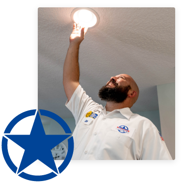 Electrician turning light bulb in new recessed light